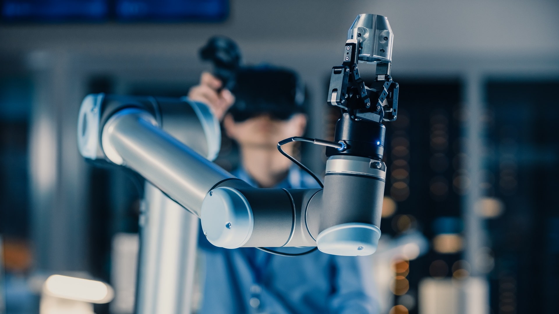 Close-up Shot of a Futuristic Robotic Arm Controlled by Professional Development Engineer with Virtual Reality Headset and Joysticks in a High Tech Research Laboratory with Modern Equipment