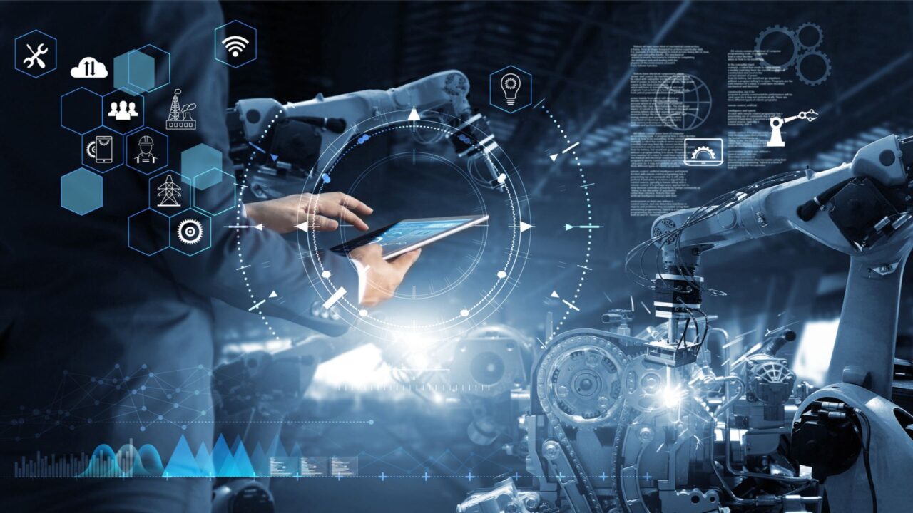 Industria 4.0: tecnico con tablet, braccio robotico, icone intelligenza artificiale